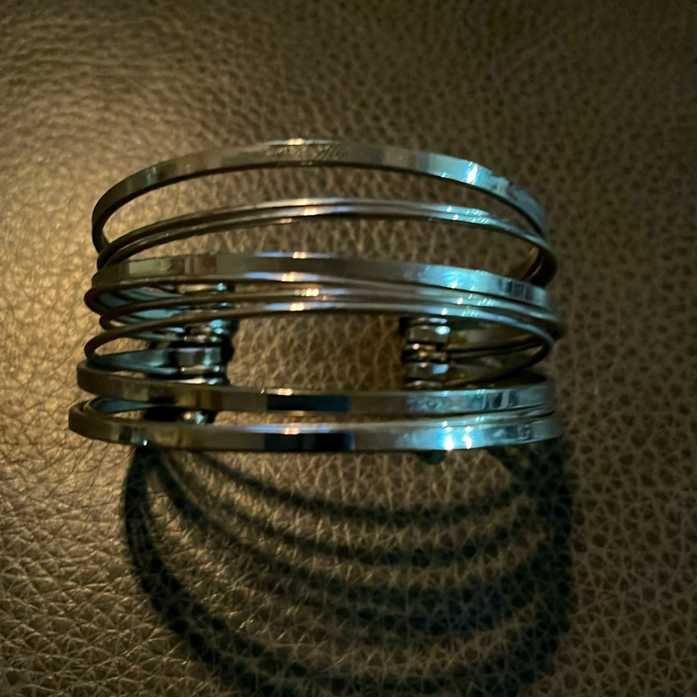 Silver tone cuff bracelet.